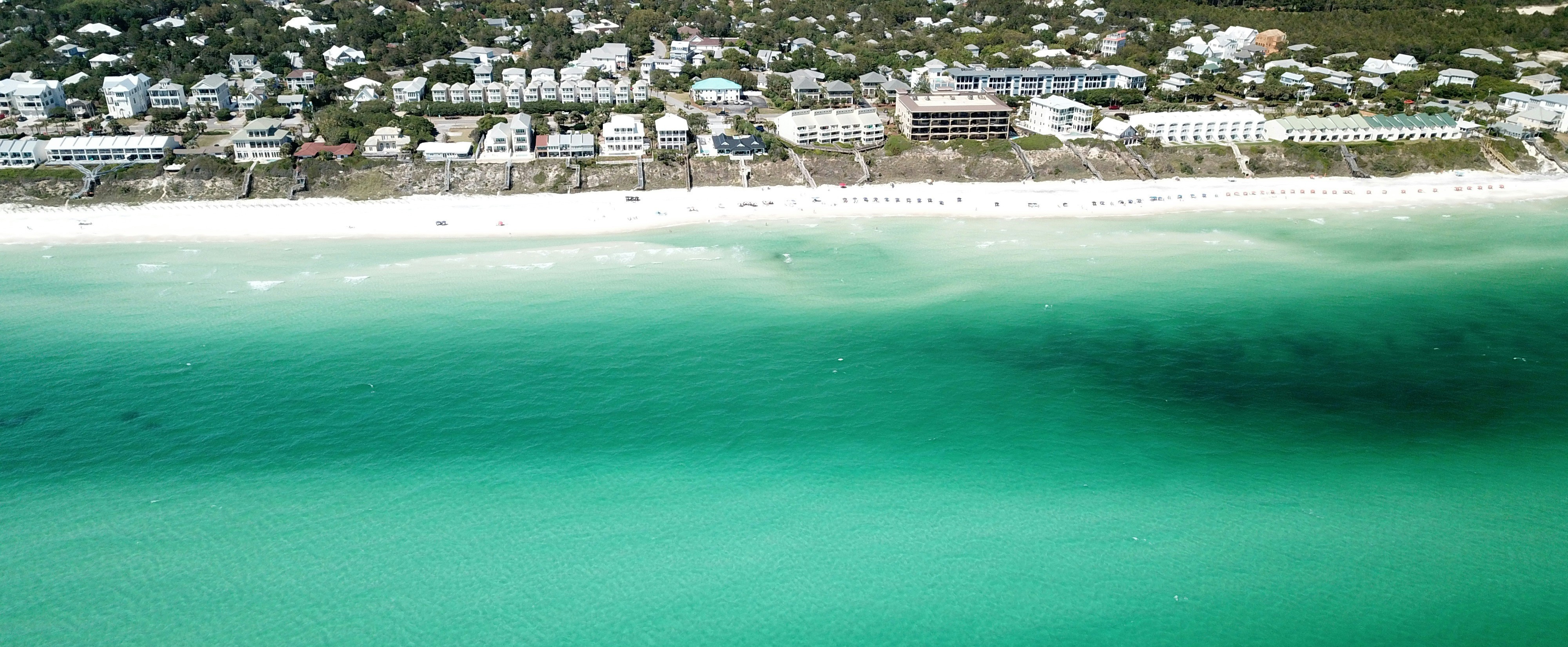 Real aerial view of Alys Beach homes and the Emerald Coast shoreline